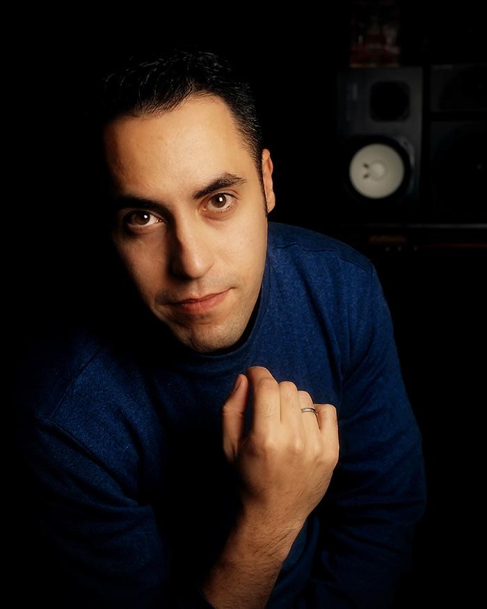 Closeup of Tom Salta in a mixing studio with a speaker in the background Closeup of Tom Salta in a mixing studio with a speaker in the background